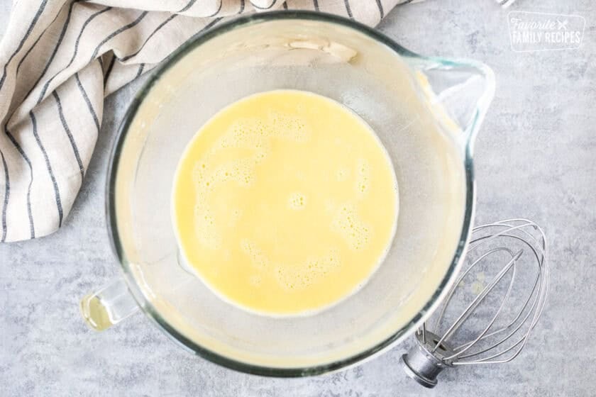 Glass mixing bowl with yeast mixture and eggs to make Sally Lunn bread