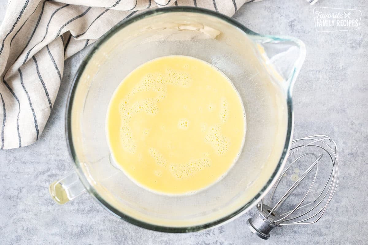 Glass mixing bowl with yeast mixture and eggs to make Sally Lunn bread