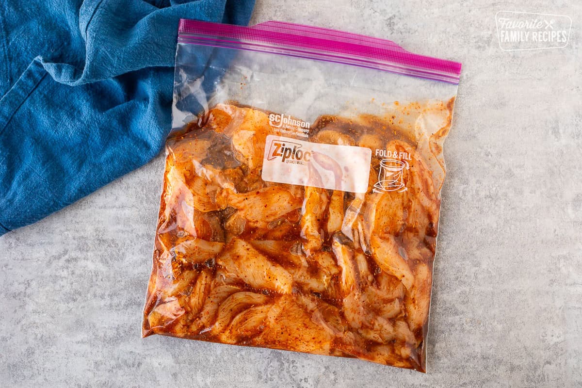 Ziploc bag with sliced chicken and chicken fajita marinade.