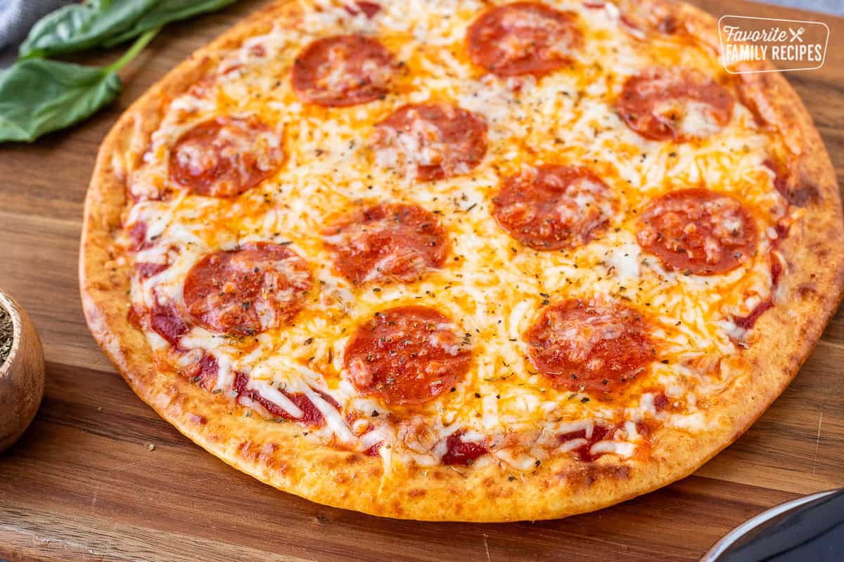 Close-up of cottage cheese pizza crust topped with sauce, mozzarella cheese and pepperoni.