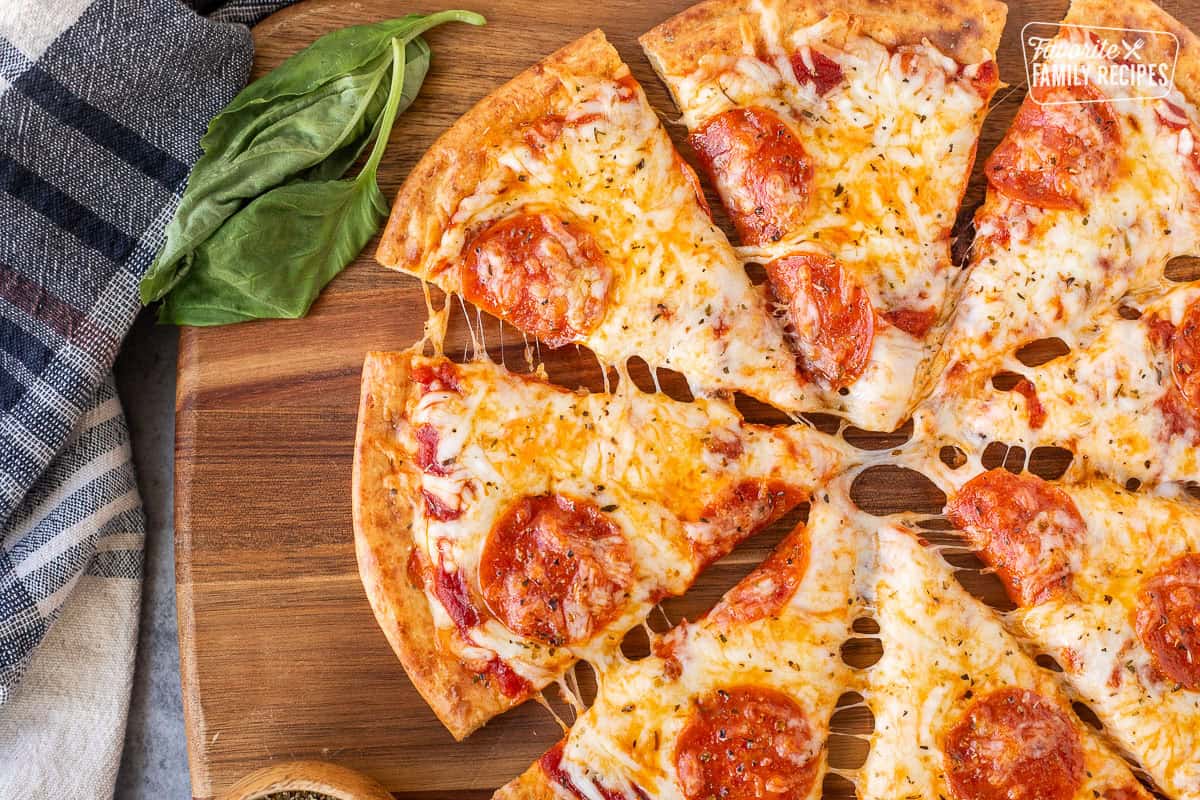 Sliced cheesy pepperoni pizza on a cottage cheese crust.