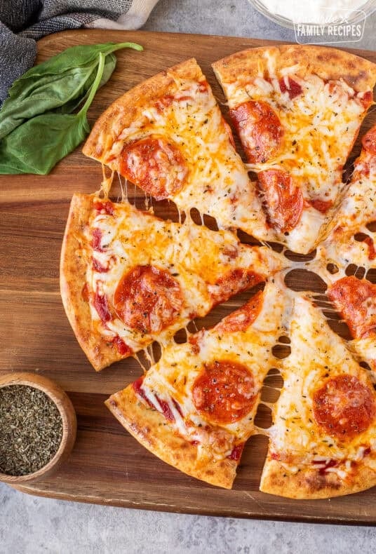 Sliced cheesy pepperoni pizza on a cottage cheese crust.