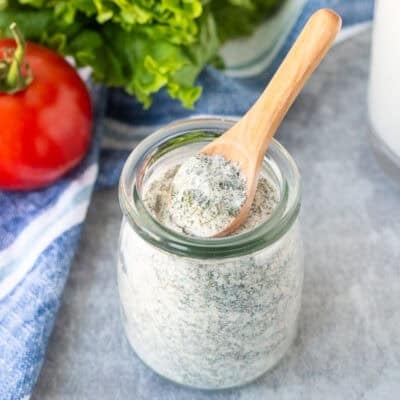 Hidden Valley Ranch Dressing Mix in a jar with a spoon.