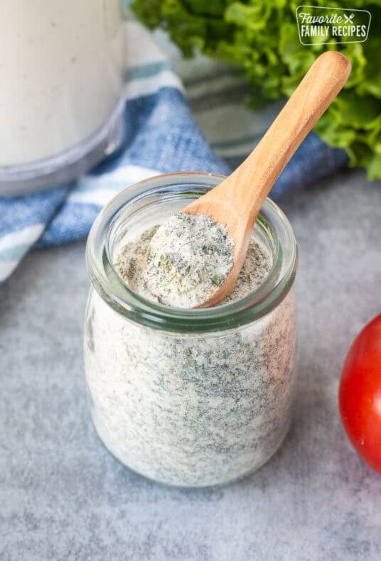 Hidden Valley Ranch Dressing Mix in a jar with a spoon.