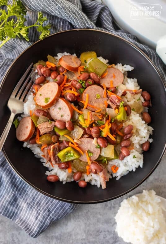 Bowl of red beans and rice with ham, turkey sausage, peppers, carrots, celery and onion.