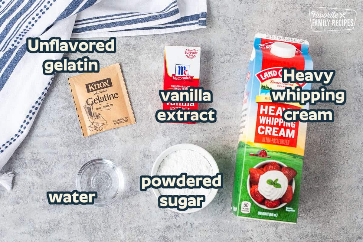 Ingredients to make Stabilized whipped cream frosting ingredients including gelatin, vanilla extract, heavy whipping cream, powdered sugar and water.