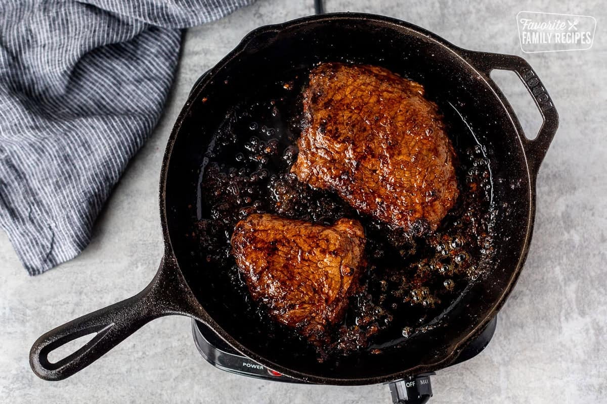 Cooked Chipotle steaks in cast iron skillet.