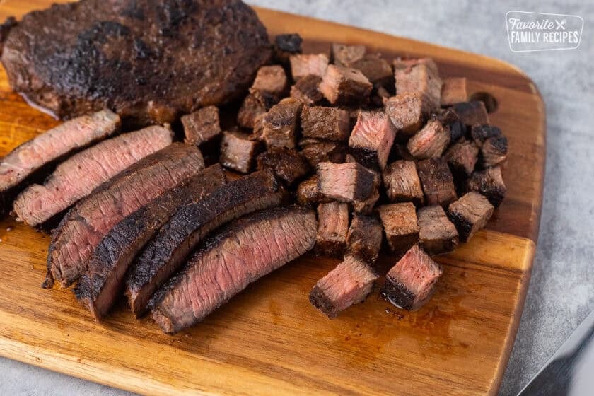 Sliced Chipotle steak on a cutting board.