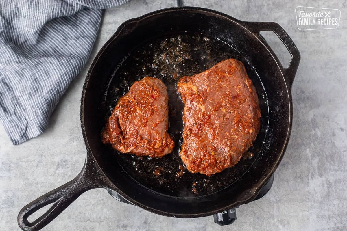 Cooking Chipotle steak in a cast iron skillet with avocado oil.