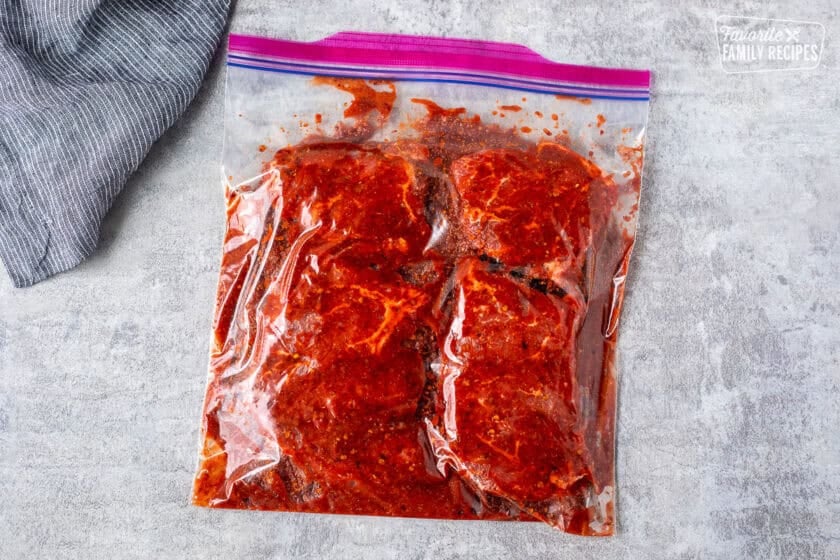 Ziplock bag of top sirloin steaks with marinade.