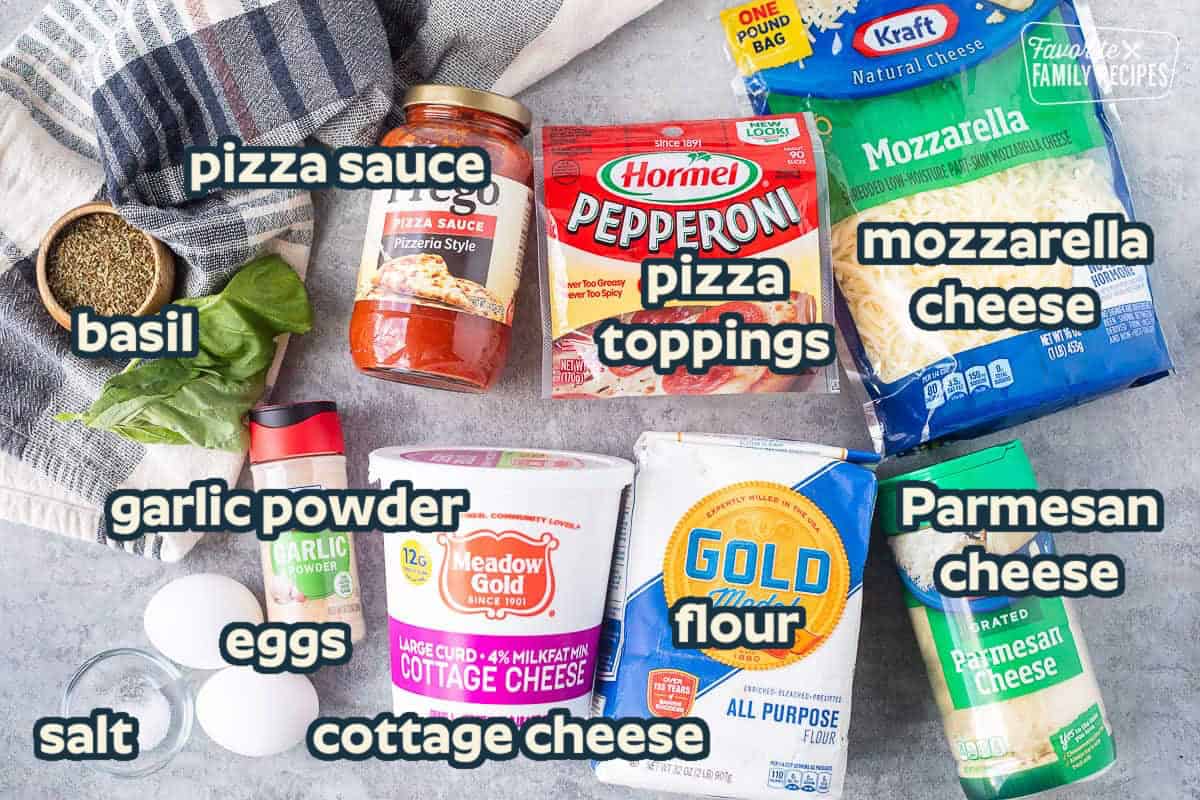 Ingredients to make cottage cheese pizza crust including mozzarella cheese, Parmesan cheese, flour, cottage cheese, garlic powder, eggs, salt, pizza sauce, pepperoni, Italian seasoning and fresh basil.