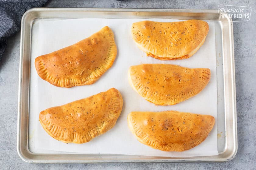Baked five calzones on a sheet pan.