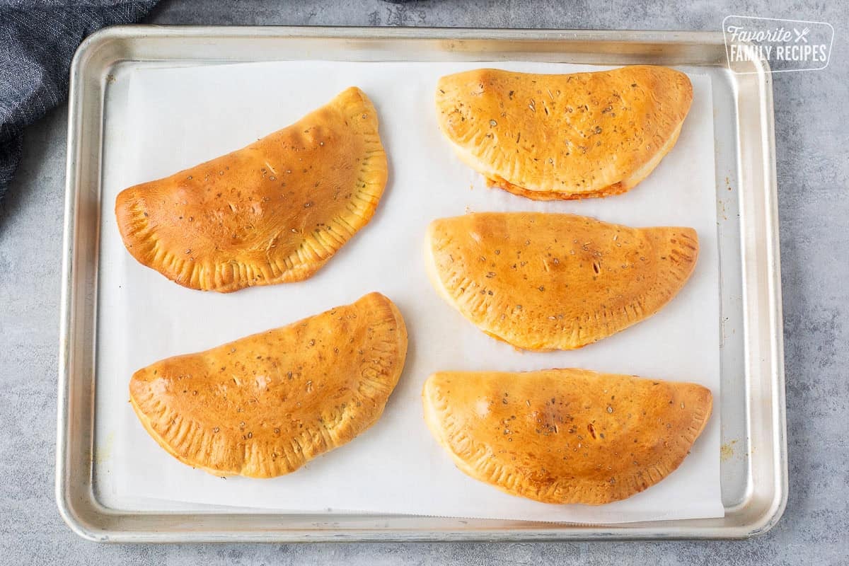 Baked five calzones on a sheet pan.