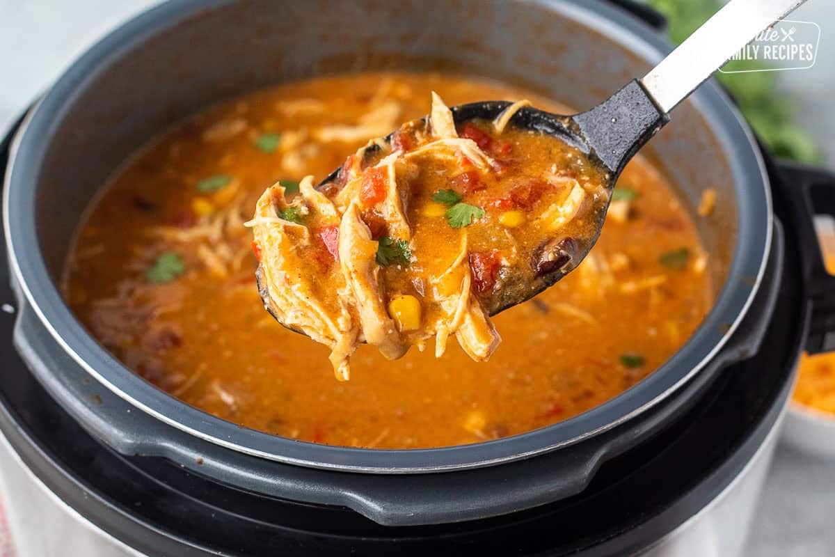 Spoon full of enchilada soup in an instant pot.