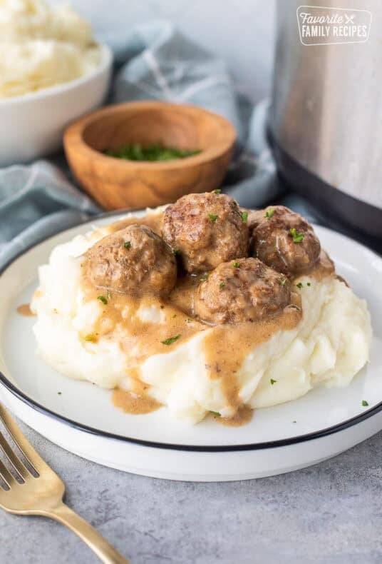 Swedish meatballs over mashed potatoes next to instant pot.