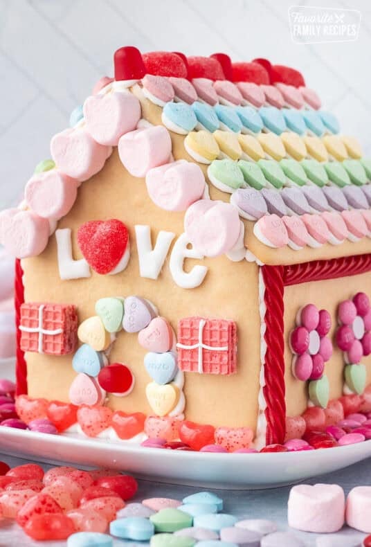 Valentine's Day Gingerbread House decorated with candies.