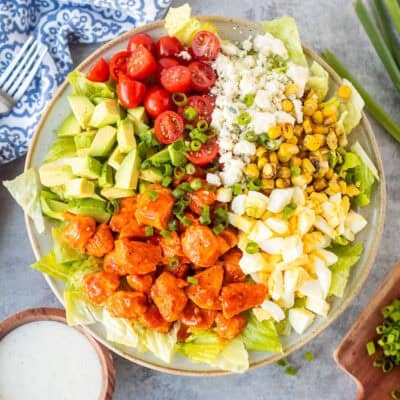 Buffalo chicken salad with lettuce, avocado, hard boiled egg, fire roasted corn, blue cheese, halved cherry tomatoes, green onions and diced chicken with Frank's red hot sauce. Ranch dressing on the side.