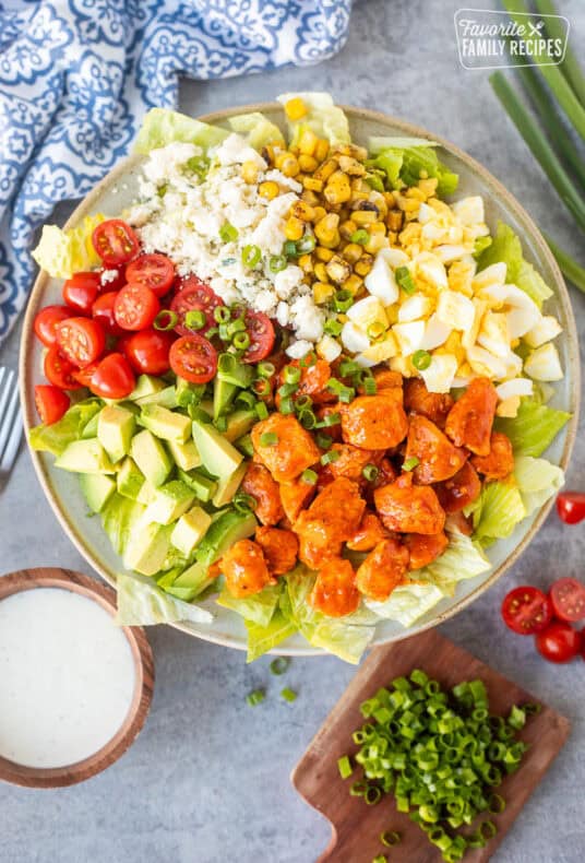 Buffalo chicken salad with lettuce, avocado, hard boiled egg, fire roasted corn, blue cheese, halved cherry tomatoes, green onions and diced chicken with Frank's red hot sauce. Ranch dressing on the side.