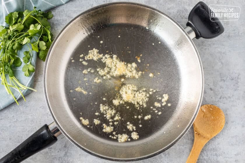 Skillet with oil and garlic.