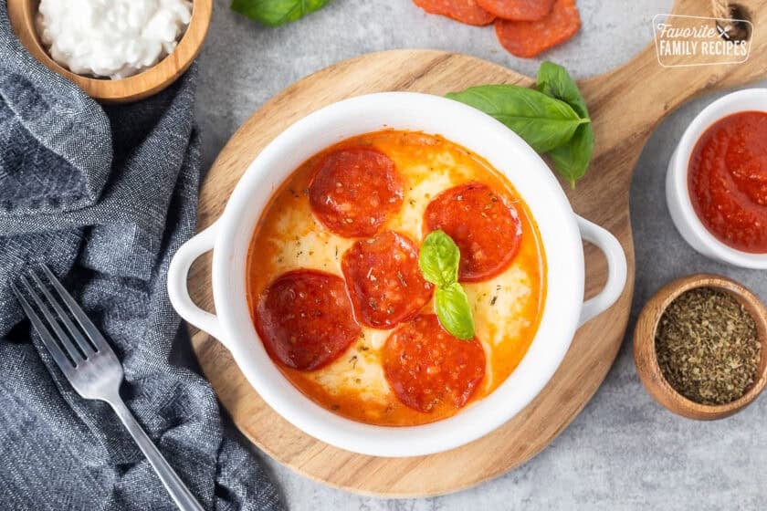 Cottage cheese pizza bowl garnished with fresh basil.