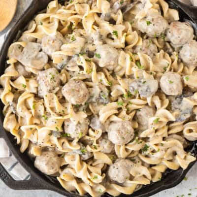 Skillet of creamy meatball stroganoff mixed with noodles.