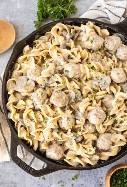 Creamy meatball stroganoff mixed with noodles in a skillet.