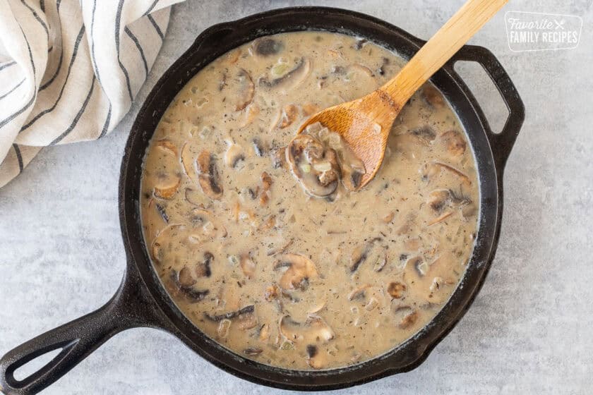 Beef broth in creamy stroganoff mixture in skillet.