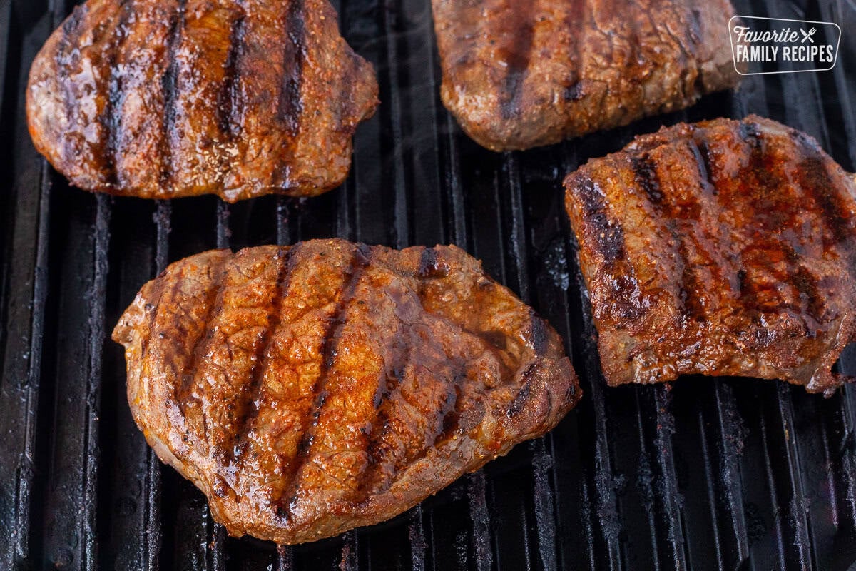 Grilling steaks on a grill.