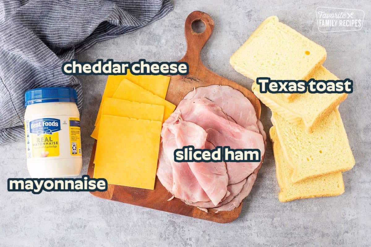 Ingredients to make grilled ham and cheese including Texas toast bread, Black Forest ham, cheddar cheese and mayonnaise.