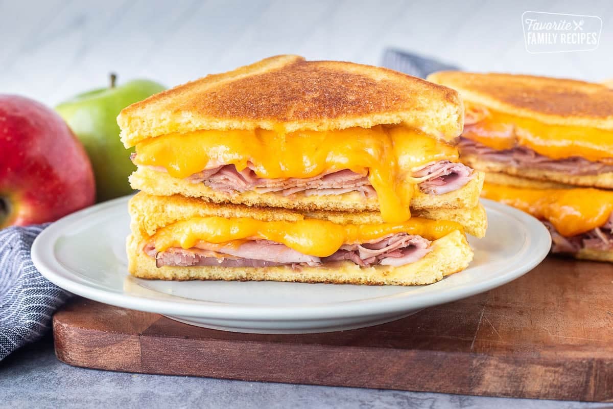 Grilled ham and cheese in half with the melted cheese coming out.