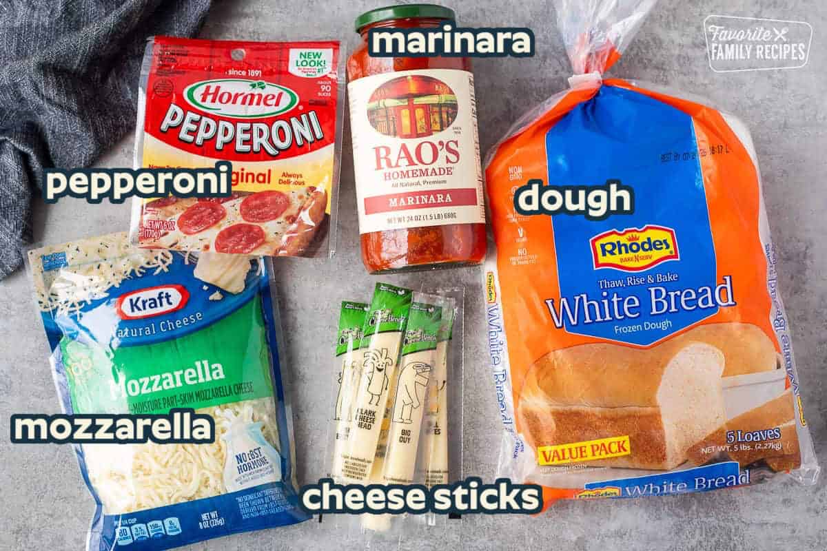 Ingredients to make easy calzone recipe including white frozen bread dough, marinara sauce, string cheese, pepperoni and shredded mozzarella cheese.