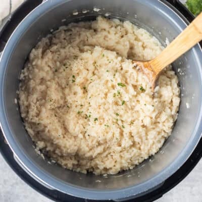 Instant pot risotto garnished with fresh parsley, salt and pepper.
