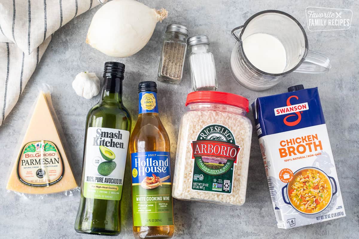 Ingredients to make Instant Pot Risotto including chicken broth, arborio rice, cream, salt, pepper white wine, avocado oil, onion, garlic and parmesan cheese.