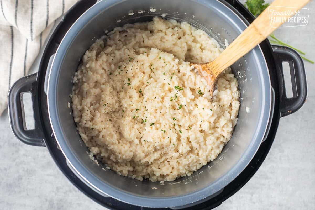 Instant pot risotto garnished with fresh parsley, salt and pepper.