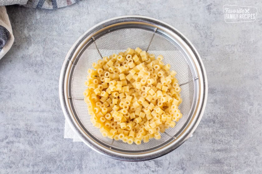 Draining dilanti pasta in a colander.