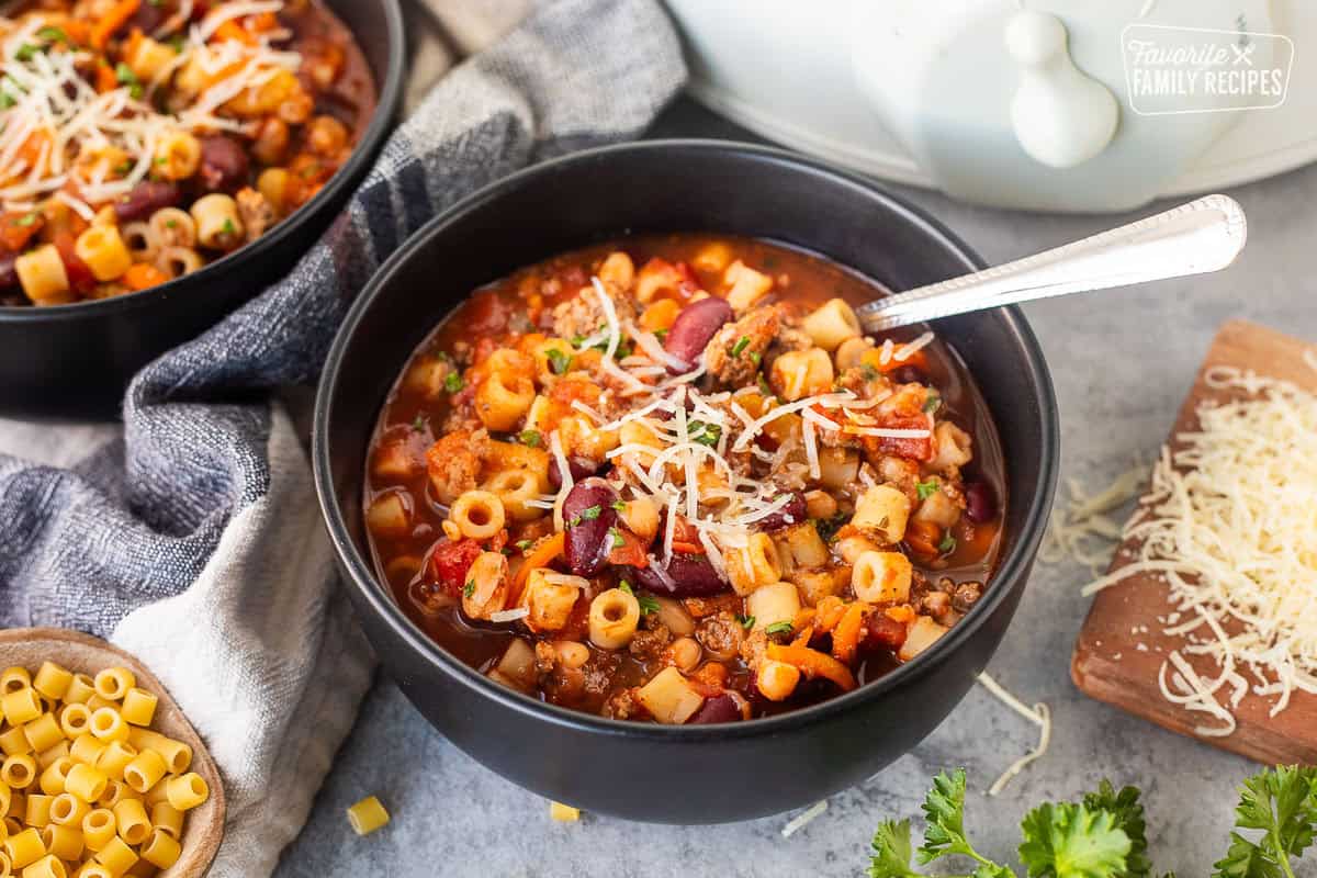 Spoon resting in a bowl full of Pasta e Fagioli.