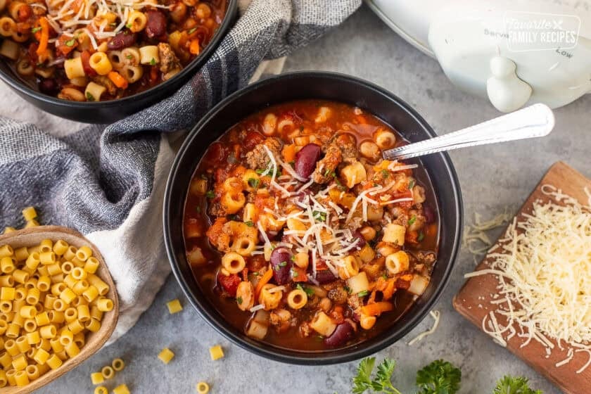 Spoon resting in a bowl full of Pasta e Fagioli.