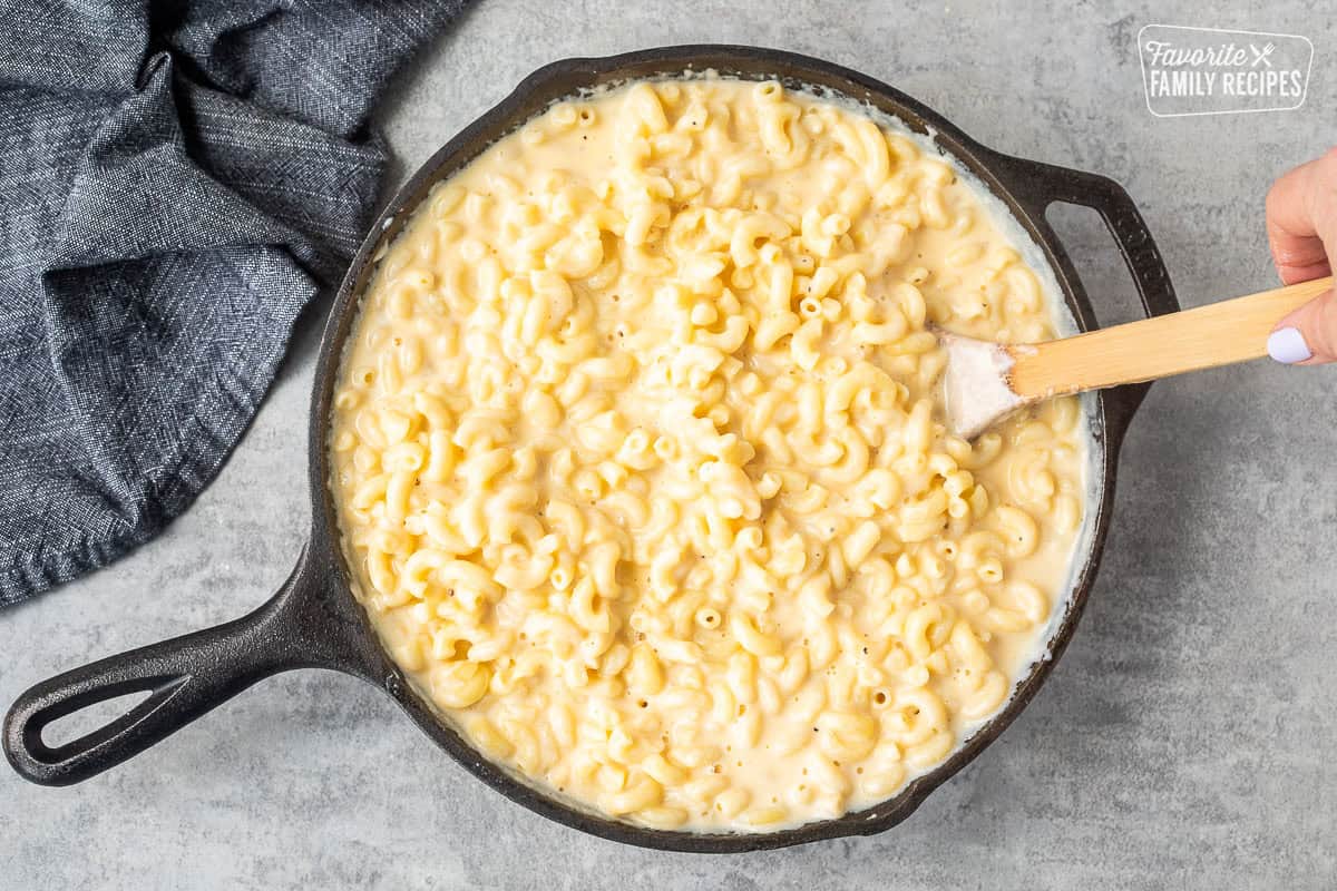 Unbaked macaroni and cheese in a cast iron skillet.