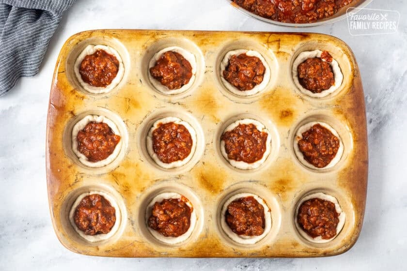 Sloppy Joes unbaked in a muffin pan.