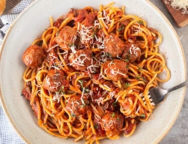 Spaghetti and meatballs stirred with pasta.
