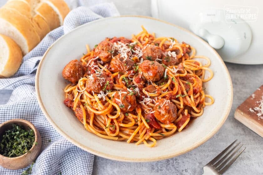 Spaghetti and meatballs stirred with pasta in a bowl.