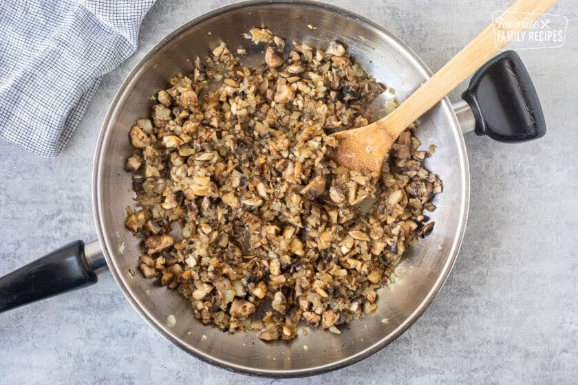 Skillet with sautéed onions and mushrooms.