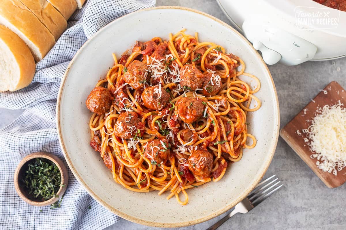 Crockpot spaghetti and meatballs stirred with pasta.