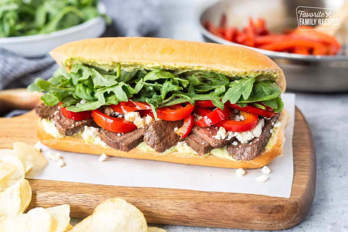 Steak Sandwich on a French roll with pesto mayo, red pepper, blue cheese crumbles, arugula and spinach mix.