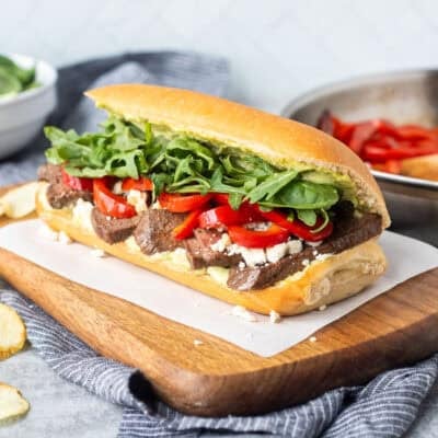 Steak Sandwich on a French roll with pesto mayo, red pepper, blue cheese crumbles, arugula and spinach mix.