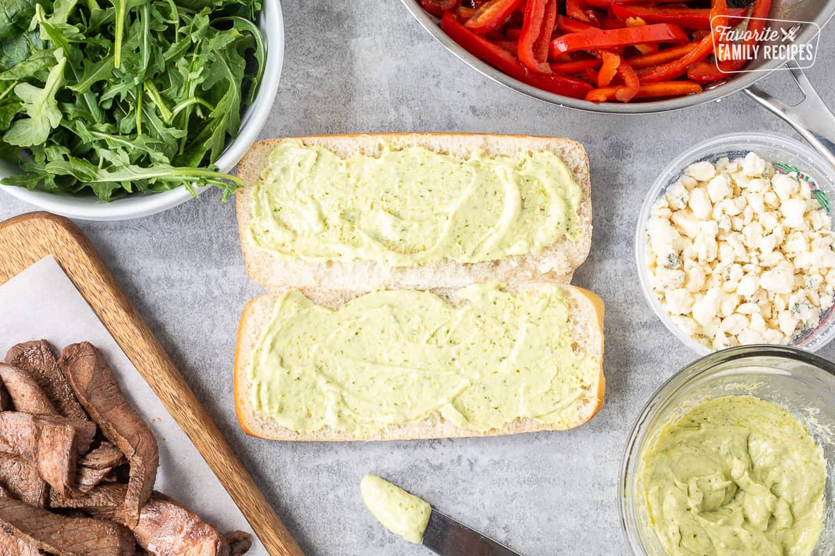 Spread pesto mayo on a French roll.