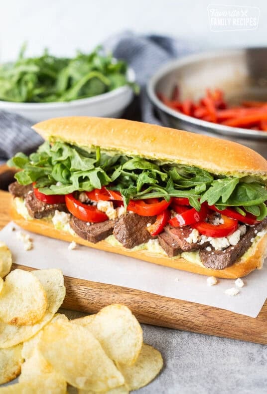 Steak Sandwich on a French roll with pesto mayo, red pepper, blue cheese crumbles, arugula and spinach mix.