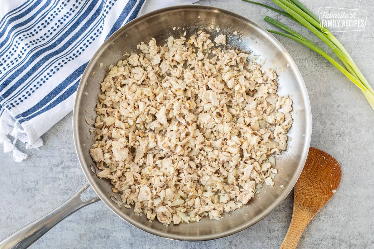 Chopped velvet chicken added to skillet.