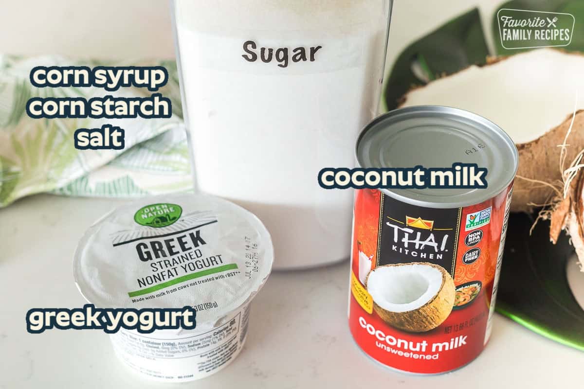 Ingredients to make coconut syrup. Sugar, Greek yogurt, and coconut milk on a counter top