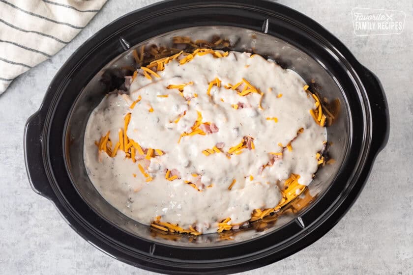 Cream of mushroom soup mixture poured on top of layered ham, potatoes and cheese.